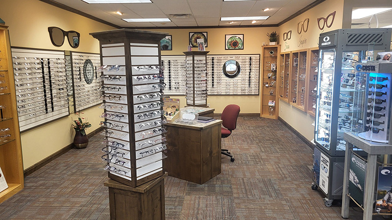 optical-boutique-eyewear-glasses-displays Inside the Midwest Family Eye Center optical gallery featuring rows of designer eyeglass frames and sunglass displays.